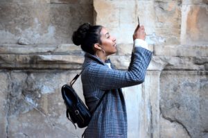 Woman holding a cell phone to record a video of herself
